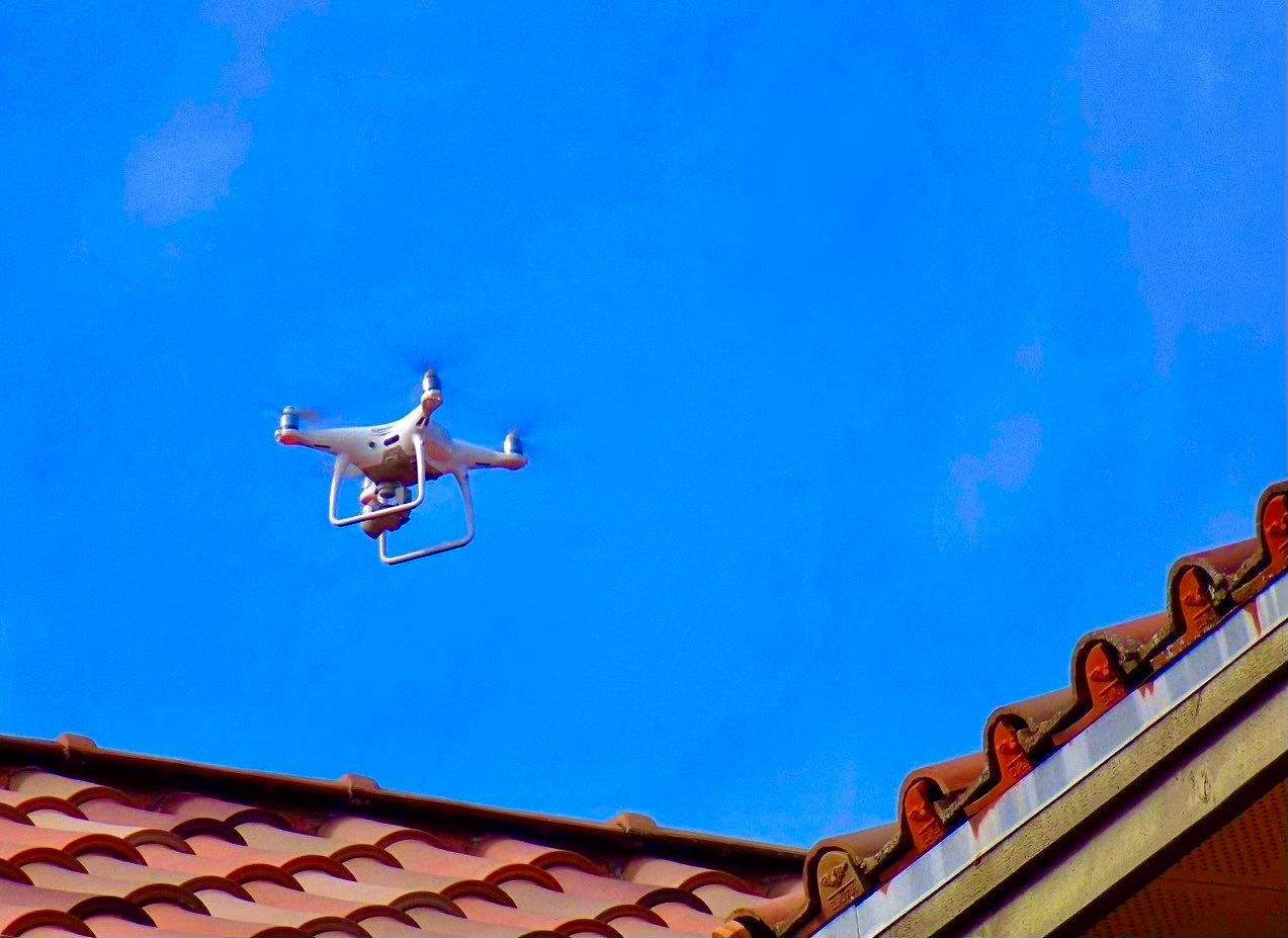 Drone operating above a residential roof