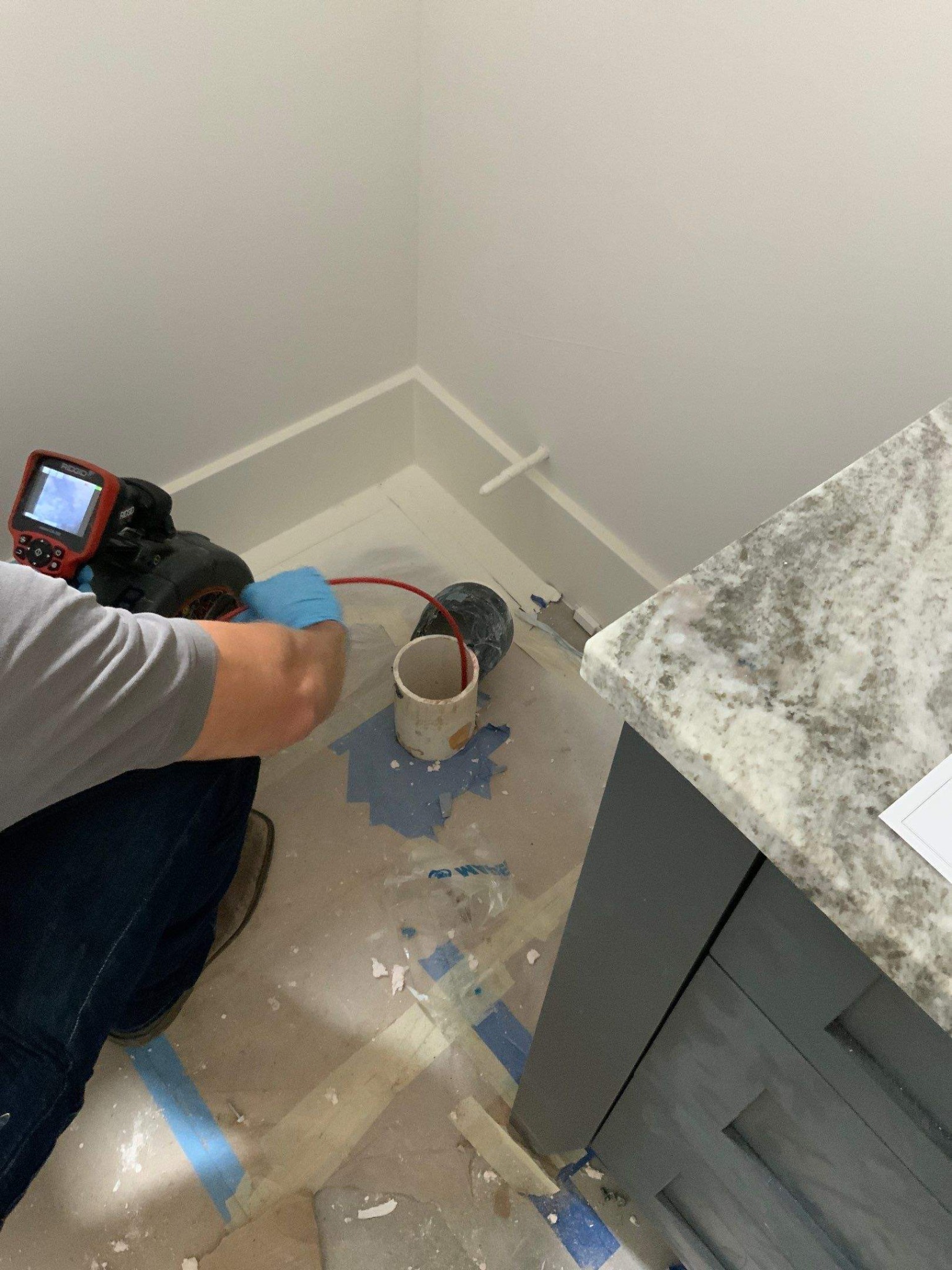 Technician using a camera at an accessible drain line