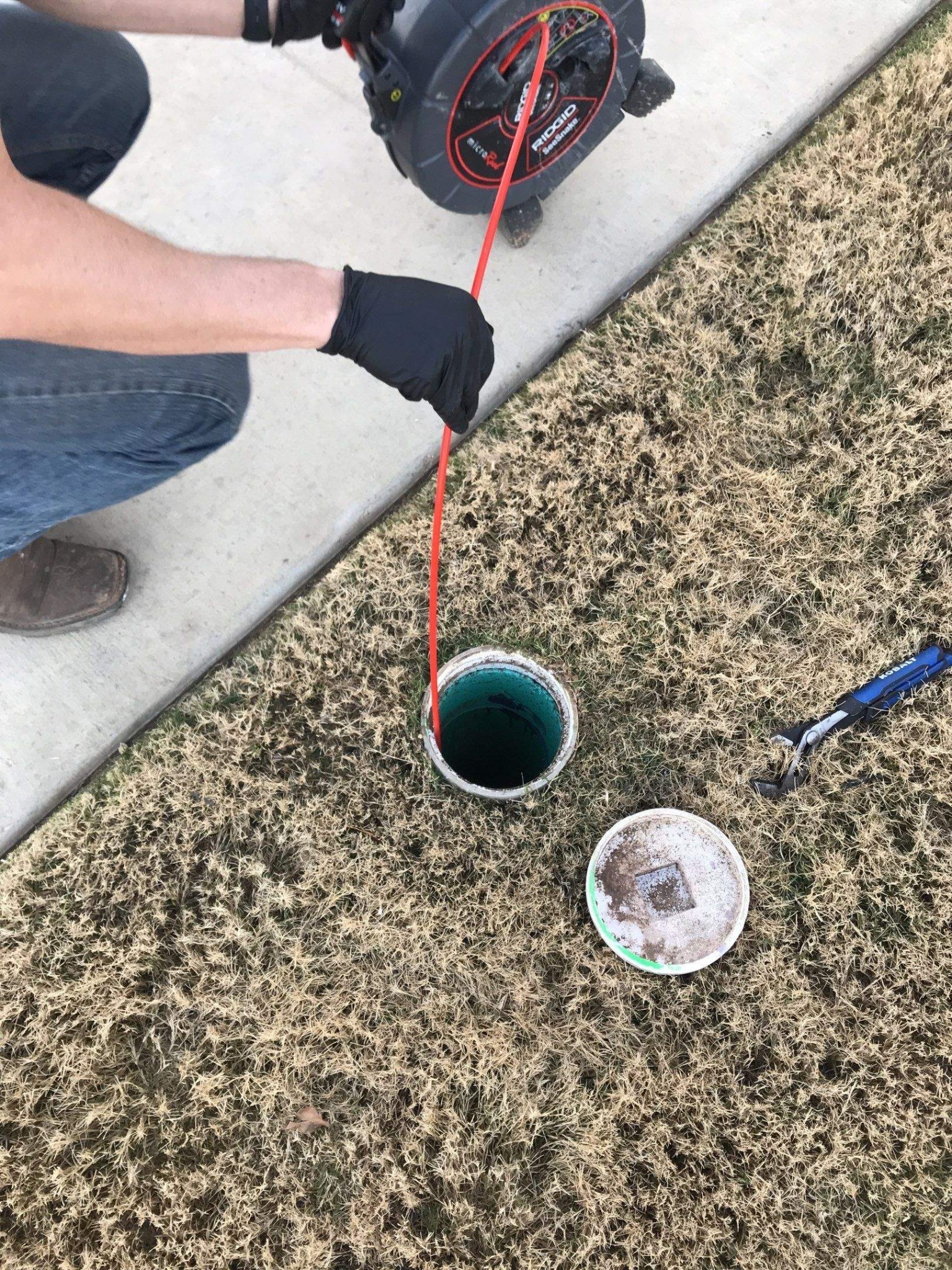 Camera cable entering an accessible exterior sewer line